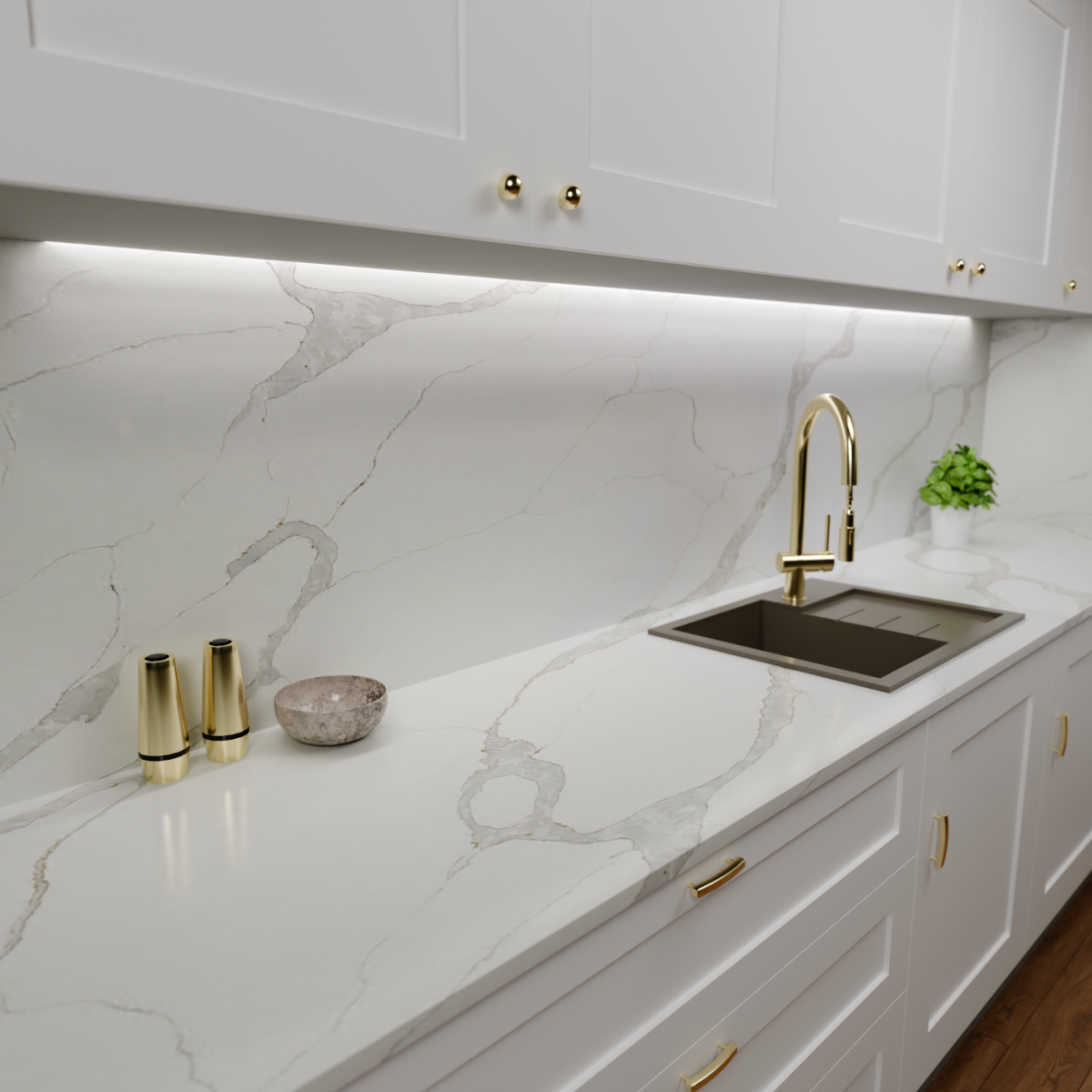 Zdjęcie przedstawia kuchnię z zamontowanym blatem kamiennym z konglomeratu kwarcowego Calacatta Gold Inspire